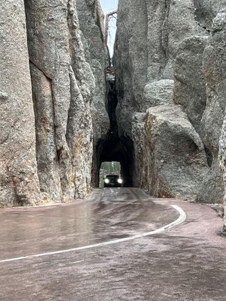 Thje Needles Highway has 2 of these tunnels. I had to fold in the morrors on my pickup. There are signs every couple of miles warning about the narrow tunnel. YET, someone pulling a large camper was heading right for it on our way out of there.