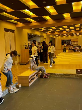 Check in, you sit on the little benches to the left, take off your shoes and store them in lockers.