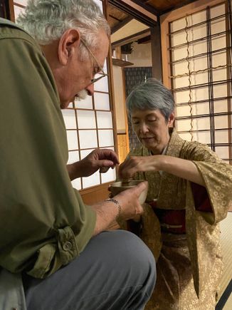 M being shown how to mix the tea. He will serve me and then, in turn, I will do the same and serve him.