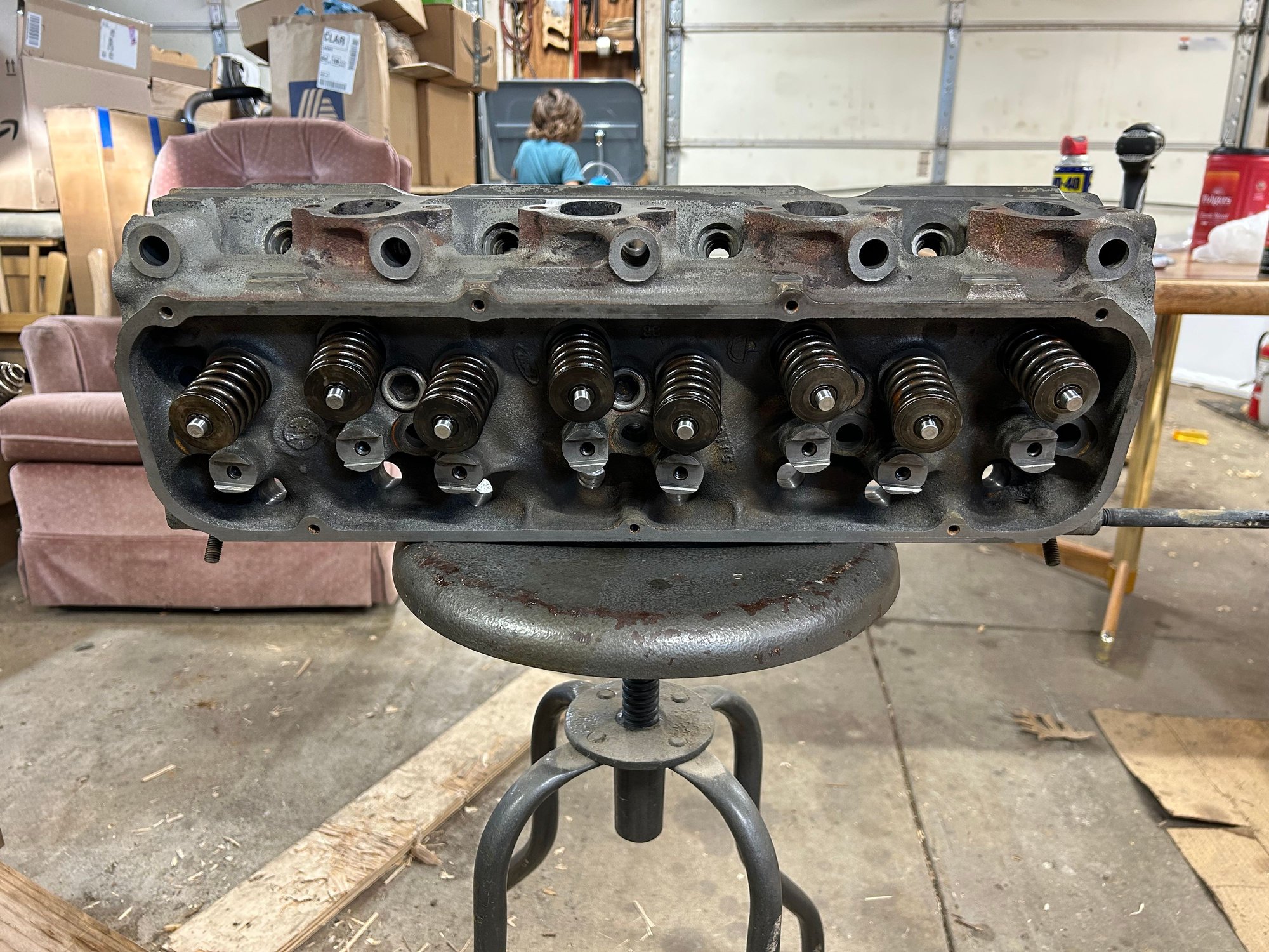 Anyways I knocked the first head out while he was cleaning and valves and got this one set aside. Then I was drying the valves. My seven-year-old was cleaning and receding them with the valve grinding compound after he was done scrubbing the last valve he decided he wanted to go back inside and play so after I was done, I rinsed off all the valve grinding compound and gave a quick scrub to the heads in the parts washer before I assembled them. 