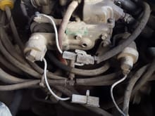 If this works, here is a picture of my carb. The choke wire is at the top and connected and working. The two near the bottom are not connected and for the life of me, I can't find a connector anywhere near the two wires.