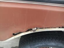 passenger side rust with rocks wedged in it