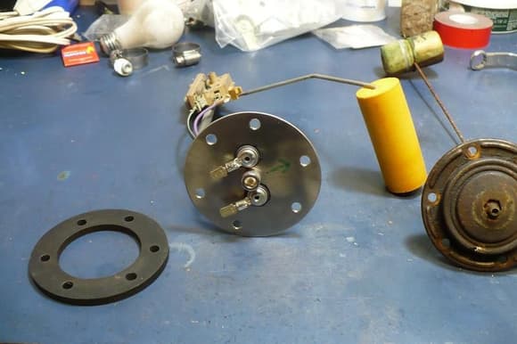 top view of fuel sender from 89 Astro mounted to base plate that will go in the aftermarket stock ss tank. Old sender is to the right of the new one.  Old one looks stock but I'm not sure.