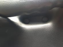 Under the door handle, are these two caps.  Pop them off.
