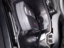 Velcro tape a garage door opener inside the cubby.