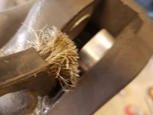 Use a wire brush and Brake-Clean to get all the crud off the piston. It should look nice and shiny after the brushing.