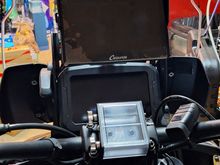 The view from the cockpit. The roll chart holder is in the center on the handlebars. The Carpuride W702 is up top. The switch for the aux lights is barely visible on the left side behind the Carpuride screen.  Teh USB hub, with voltmeter, is just to the right of the roll chart holder on the handle bars.