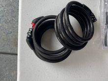 Lock cables, used to lock helmet..via face guard. 