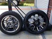 Obviously no exact number for difference but here is a little line showing the stock 16 next to an 18 with a 180/55/18 tire. 