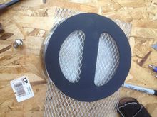 I cut a piece of mesh type material I found at a hardware store for behind the medallion.