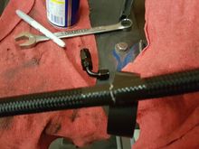 Use electrical tape - and tightly wrap on each side of the line to cut - tape keeps the shield from unraveling and becoming an unmanagable rats nest - that cannot be inserted into the hose end..., it also keeps wire secure and not sticking your finger - which hurts like hell