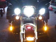 CD Lighted windshield bar w/turn signals, Cirius LEDs on the crash bar canted out 30 degrees, Custom Dynamics turn signals, homemade LEDs in the vent (they fire sideways = forward), driving lights flashed on with high beam.