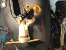 The pump assembly- rotate towards the front of the bike and gently lift it out