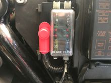 Perfect place to mount the fuse block which was under the left side cover below the seat. The battery is located just behind it.