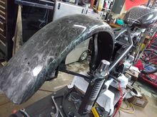 The fender was pulled from scrap storage. I believe it's a trailer fender from a farm supply store. the ghost skull design appears marble- like at a distance.