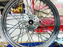 So I found a brand new rim and kept the old spokes and hub, laced, trued up and balanced on a cheaper truing stand. Good times.