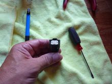 I know the insert is still in place here, but with it removed you can look inside the plug and see the little latches that hold the pins in place.  I used a small jewelers screwdriver to release the pin and at the same time push it out the back using a paper clip.