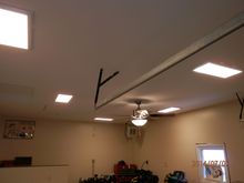 L E D flat panel lights and ceiling fan with heater in the back corner