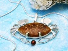 HoLy Crabcakes Batman! Ammonite shell cabochon and pearl set in sterling silver with 14k yellow gold accents.