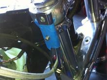 Here is first fitment of spotlight bar. The bolt on the 49mm kuryakn clamp sticks out and will interfere with the windshield mounting hardware. I masked the bracket off in prep for a dremel cut off wheel to cut this flush with light bar vertical L-bracket.