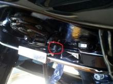 On 2010 RK's there is a small metal post where the new brake line connector is supposed to connect to the frame, however, the Drag Specialty brake line doesn't have an indent to fit around the post so there are two options: 1) grind down the post, 2) insert a 3/16" thick spacer between connector and bike.  I chose the spacer and it seems to be working good.