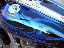 FUEL TANK PAINT
Airea 5150 - Painter
Black Base with Dark Blue Ghost Flame
Silver Metal-Flake Tribal Flame w/ Air-Brushed Skulls
Cobalt Blue Candy over Tribal Flames then Pinstriped
H-D Flush Mount Fuel Gauge
Several Coats of High Gloss Clear Coat