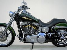 **Front End**
*H.D. 2006 Wide Glide 21" front wheel 
*H.D. Billet Fork Slider Dust Covers
*H.D. Chrome Lower Fork Sliders 
*H.D. Classic Chrome Brake Caliper Insert 
*Kuryakyn Front Axle Nut Covers 
*H.D. Tinted turn signal lenses 
*H.D. 2008 Screamin Eagle Dyna front turn signal mounts   
*H.D. 2006 Deuce headlight 
*H.D. 2006 Sportster Custom, headlight mount 

**Hand Controls**
*H.D. Aileron Hand Grips 
*Routed front frame and console wire harnesses to left side of the bike
*Redressed all harnesses, cables, and hoses
*Removed reflectors, all factory decals, VIN, and emissions labels, and vapor canister

**Engine**
*H.D. 10 Row Oil Cooler
*H.D. Screamin Eagle Yellow 10mm spark plug wires
*Home made spark plug wire supports
*Relocated horn 
*Installed banana jack on bottom of coil cover for battery tender

**Foot Controls**
*H.D. 2005 Forward control kit
*H.D. 2006 Polished Stainless Steel Gear Shift Linkage
*Removed the original shift lever without removing the primary
*H.D. 2007 Screamin Eagle Springer foot pegs 
*H.D. 2007 Screamin Eagle Dyna Polished Stainless Steel Footpeg Mounting Pins 
*Grinded down rear foot peg stops so pegs will tilt in more when in the up position

**Rear End**
*H.D. 2007 Street Glide Air Shocks
*Modified lower belt guard
*H.D. Script Rear Axle Cover Kit
*H.D. Tinted turn signal lenses 
*Custom Chrome lay down pyramid license plate mount 
*Kuryakyn Deluxe Smoked Tail Light
*Painted LED light face plate and inside of lens sides flat black