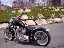 Rigid frame, 107" S&amp;S, 6 speed, 34 degree rake, narrow belt drive,  12" ape's, spring mounted solo seat (tuck &amp; roll), and wide whites.