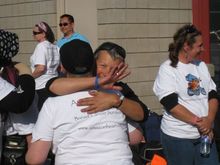 Linda hugs a friend and waves to Joe.