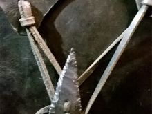 The bag ties I bought a couple of flint arrow heads and used a diamond drill to put two hole in them so I could sew them to the bag.
