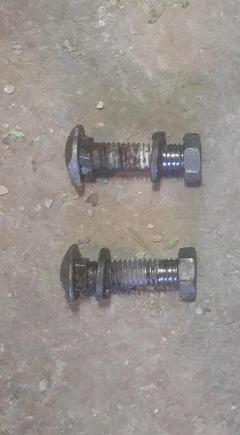 The tranny plate front mount bolts.  Either cross-threaded, or they used nuts with the wrong thread pitch.