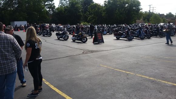 A parking lot full of bikes.