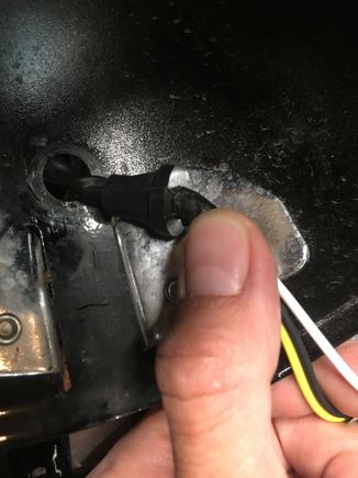 I just used a large flathead screwdriver and used it to gently pry at the inside and worked my way around it. I used a larger flathead that was dull so I wouldn’t cut anything. It comes out very easy. You’ll have to depin the connected to get the wiring out but that’s easy. Lots of YouTube videos. 