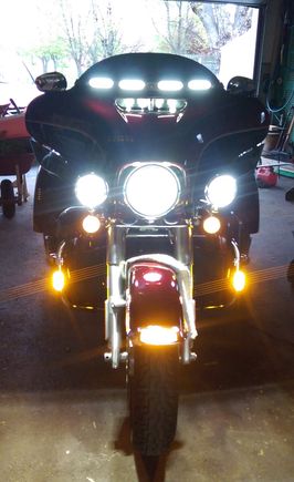 CD Lighted windshield bar w/turn signals, Cirius LEDs on the crash bar canted out 30 degrees, Custom Dynamics turn signals, homemade LEDs in the vent (they fire sideways = forward), driving lights flashed on with high beam.