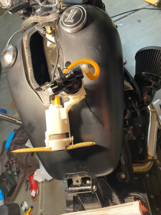 The pump assembly- rotate towards the front of the bike and gently lift it out