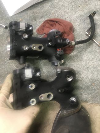 Installing the injectors and fuel rail/hose to the new throttle body. Also, put the flanges on the ghrottle body before you put the rubber gaskets on.