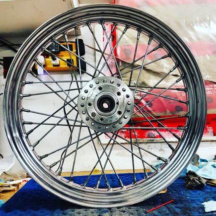 So I found a brand new rim and kept the old spokes and hub, laced, trued up and balanced on a cheaper truing stand. Good times.