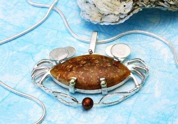 HoLy Crabcakes Batman! Ammonite shell cabochon and pearl set in sterling silver with 14k yellow gold accents.