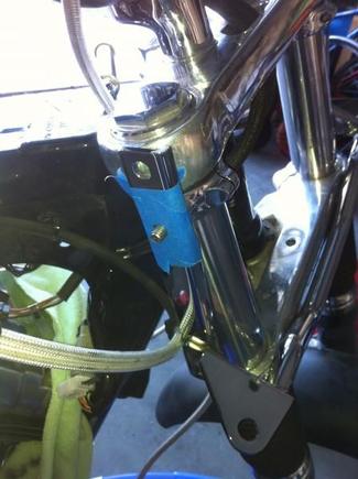 Here is first fitment of spotlight bar. The bolt on the 49mm kuryakn clamp sticks out and will interfere with the windshield mounting hardware. I masked the bracket off in prep for a dremel cut off wheel to cut this flush with light bar vertical L-bracket.