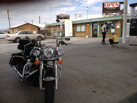vidal junction sept 8 2012 during my first 1k/24

here's the only pic i took that wasn't a time stamped shot of the odometer. it was a quick shot with the iphone. vidal junction sits at the intersection of 95 and 62 near the middle of the desert between interstates 10 and 40. the station carries diesel and 87 octane. i stopped there after realizing the road king probably had a 5 gallon tank because i had less than a quarter tank left. needles is 50 miles away and i decided to go for it. the fuel light came on with 20  miles to go. luckily the last 20 miles were mostly down hill. i kept the speed at 60 mph, talked to the bike (a lot) and pulled into the shell station in needles with .13 gallons left.
