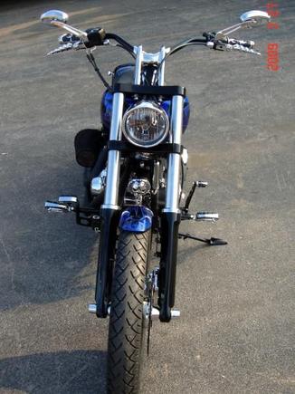 FRONT VIEW
HHI Custom Trees - 5deg, Mid-Glide, Black
Powdercoated Lowers, Handlebar &amp; Headlight Shell
Kuryakyn Turn Signal Mirrors, Handgrips, Footpegs
21" Front Renegade Wheel with Metzler Tire