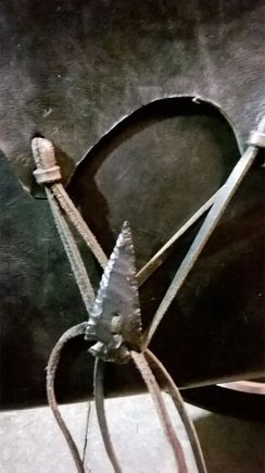 The bag ties I bought a couple of flint arrow heads and used a diamond drill to put two hole in them so I could sew them to the bag.