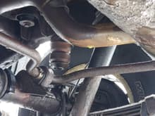 You can see the drip on the exhaust just before the muffler, but you can also see the yellow (brass?) "clip" on the torsion bar