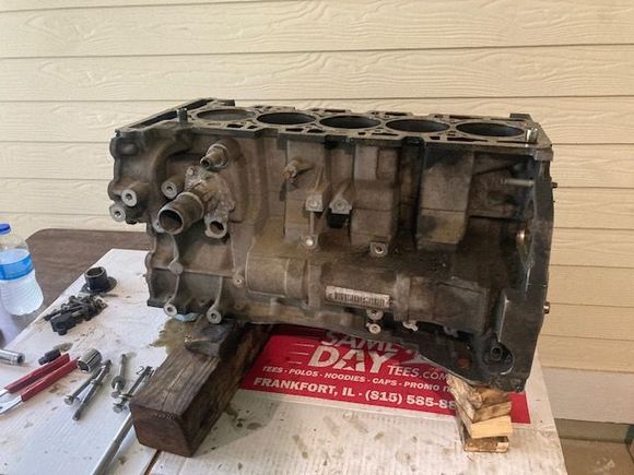 Engine on work bench; wood underneath ensures the weight of the block is not applying pressure on the crankshaft.  