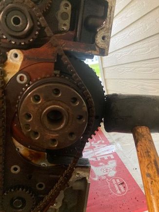 .....then take a rubber mallet and give the crankshaft a few whacks while you are trying to pull the chain off the crankshaft gear.  After a few whacks, I was able to break it loose.  

All of this can be avoided by waiting to remove the bearing brace/caps until AFTER this balance shaft chain is removed.  