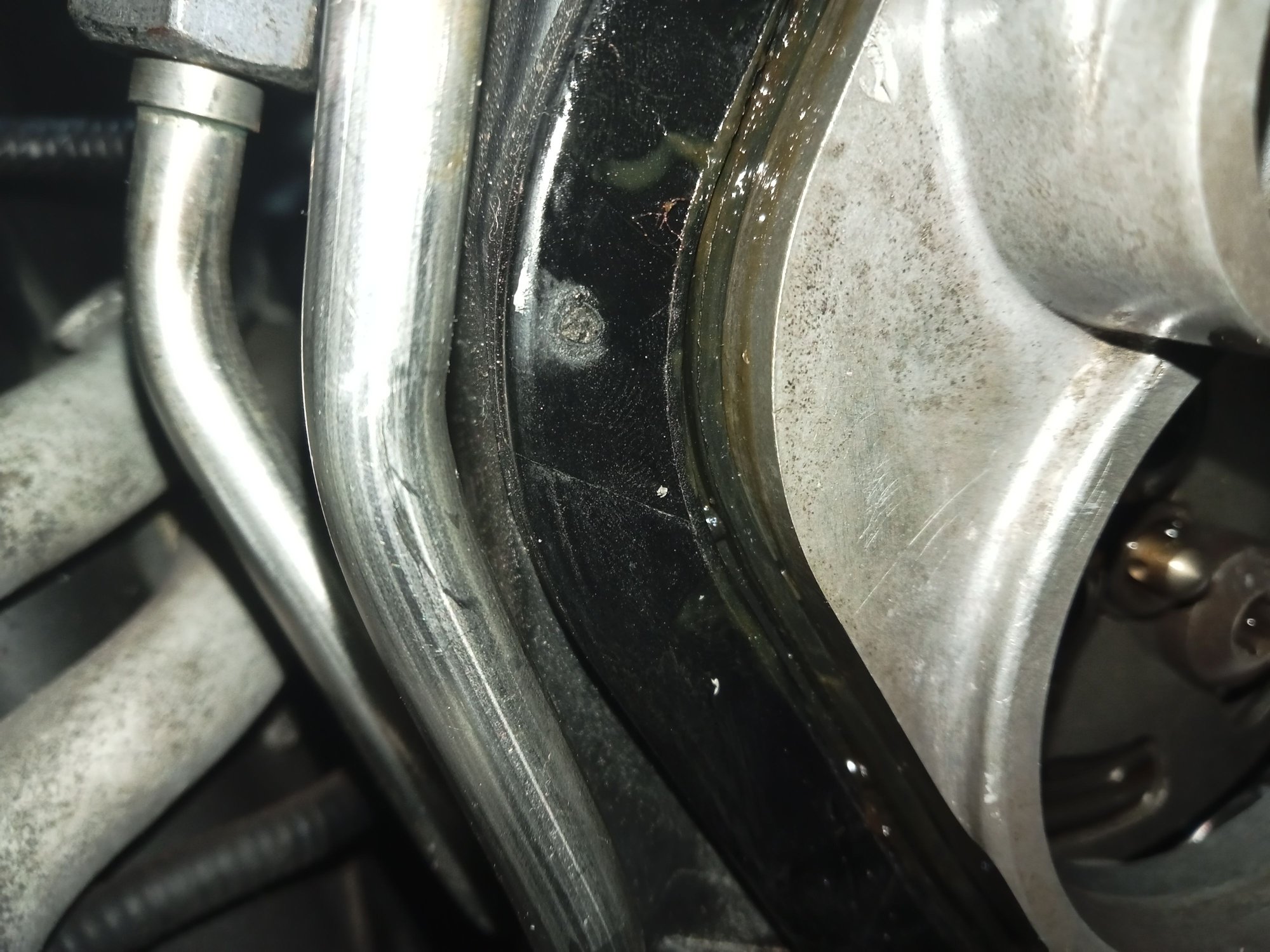 The seal under the rocker cover is easily pushed out of place and into the engine when sliding the timing cover on. You can see it's ok here, all covered on oil.
