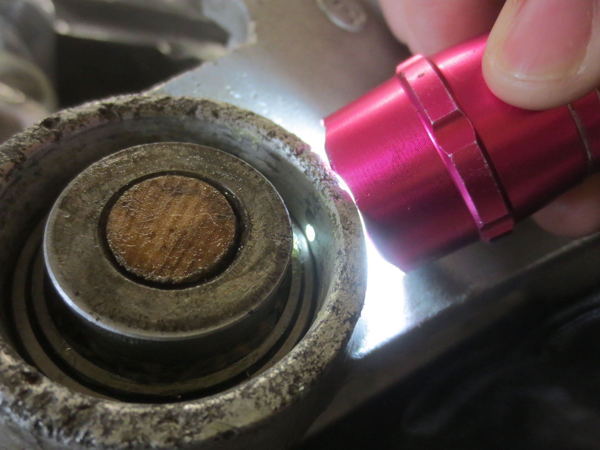 Hub casting on its side, wood dowel replaces pin, everything still in place