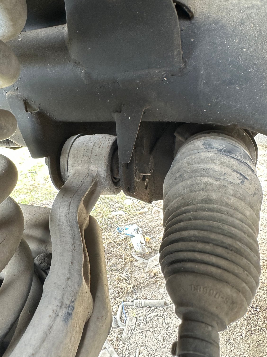 Pic of left side lower contol arm on a 2000 X308 at a local pull and pay yard this weekend. Shows bolt inserted from the rear, just ahead of the steering linkage.