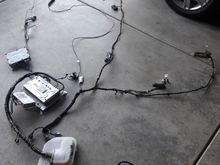 Some of the entertaiment components laid out connected by the telematics harness before starting. They we're stripped from a salvaged XJL.