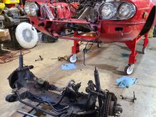 Raison d'etre.  This was last night.  Notice I spun the car around.  Worked like a charm.  I wanted to use my forklift to support and lower the sub-frame.  I might have to install my long forks to remove the IRS.  